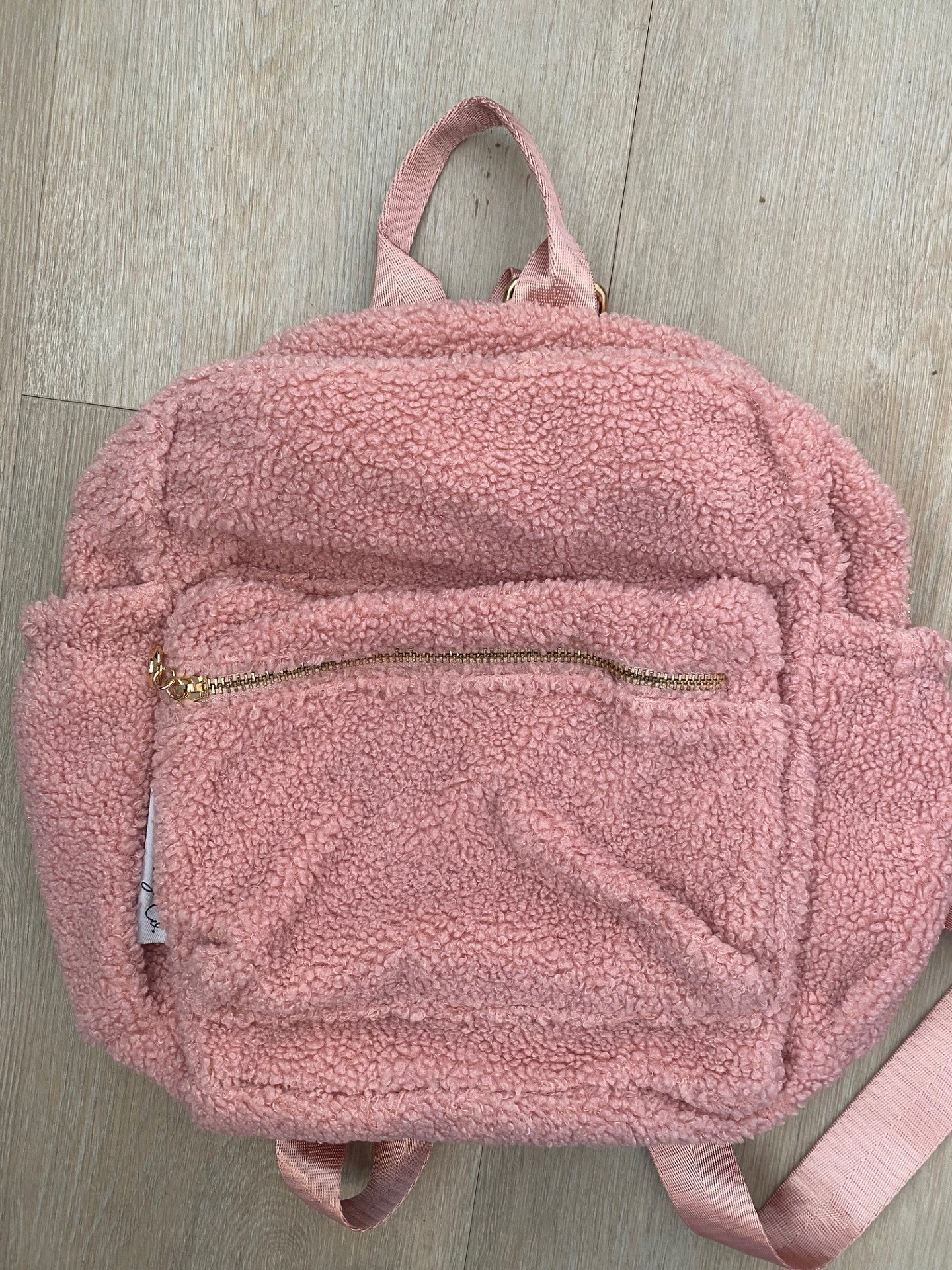 Pink backpack ** MATERIAL UNDER ZIP IS SLIGHTLY LIFTED**