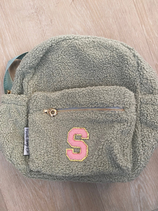 Sage backpack with initial 'S' in pink  **SLIGHT TEAR ON SIDE POCKET*