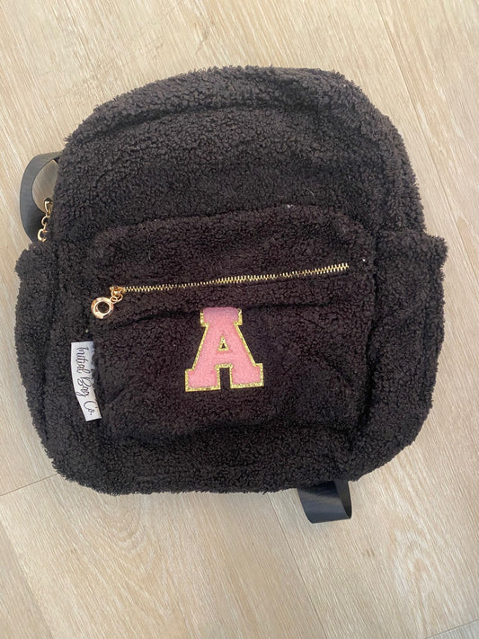 Black backpack with initial 'A' in pink ** FRONT ZIP IS NOT STRAIGHT**